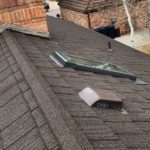 denver roof with asphalt shingles, chimney and skylight