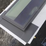 closeup of flashing around skylight on a roof