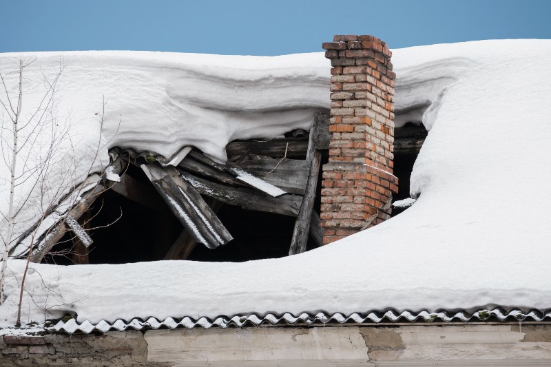 collapsed and sagging roof under snow