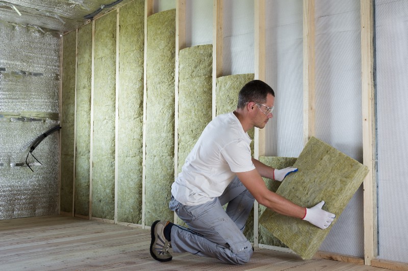 man installing insulation panels
